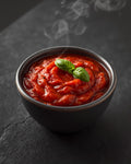 Rich tomato pasta sauce in a stoneware bowl