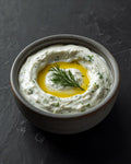 Tzatziki with dill in a stoneware bowl